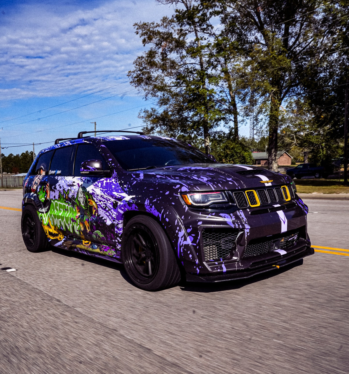 Purple splatter show wrap with character art on a Jeep Grand Cherokee Trackhawk, designed by JCD