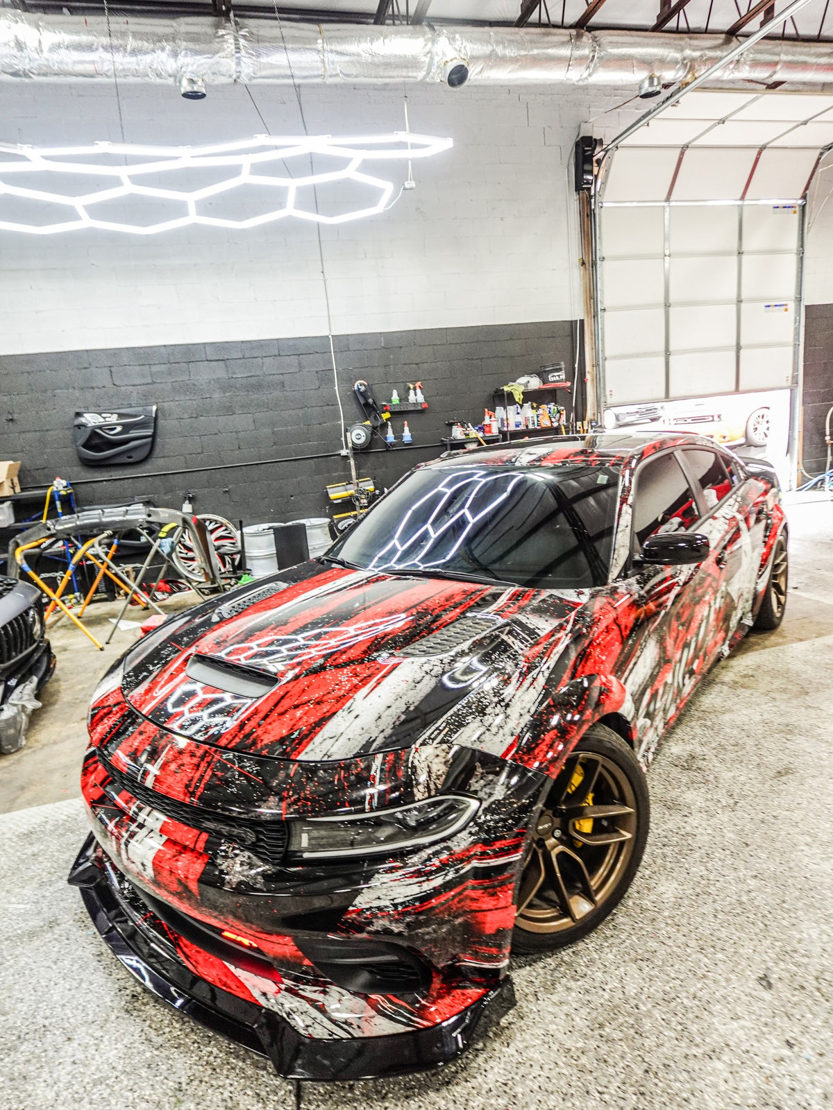 Red and white carbon-star abstract full wrap on a Dodge Charger, designed by Jay's Car Designs