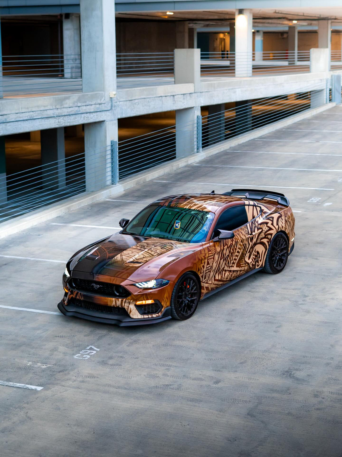 Samoan tribal show wrap on a Ford Mustang 5.0 in a parking garage, designed by JCD