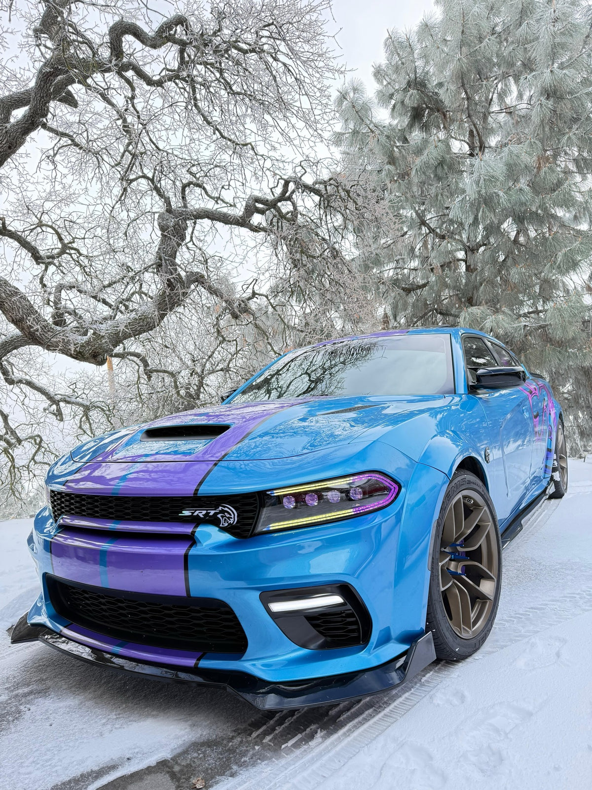 Custom chrome-fade Hellcat decal on a blue Dodge Charger in the snow, designed by Jay's Car Designs