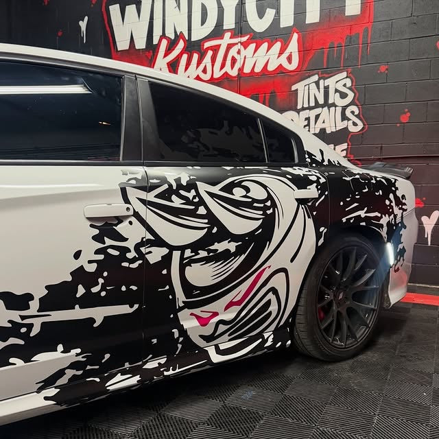 Custom partial black and white decal on the side of a white Dodge Charger, designed by JCD