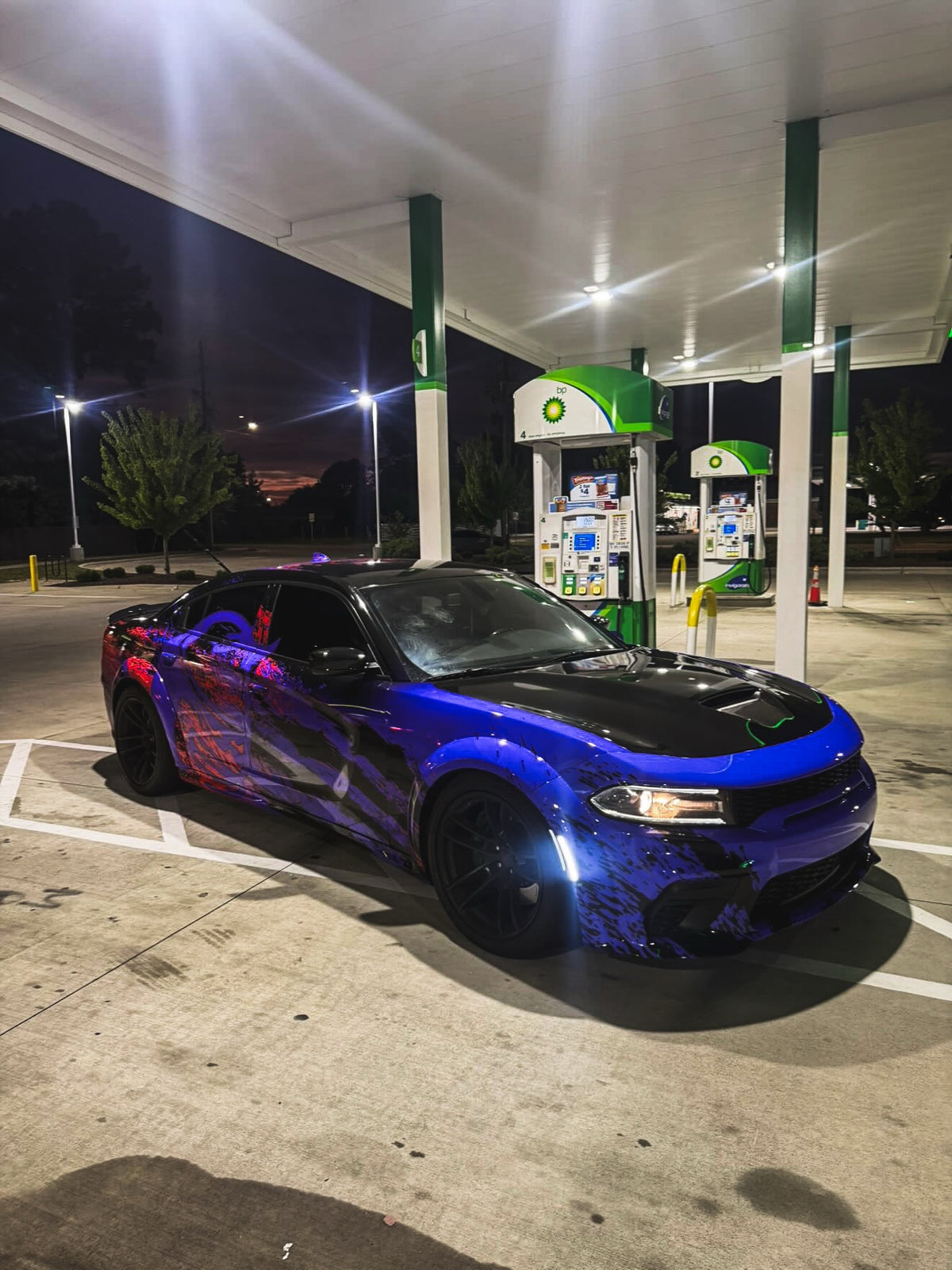 Two-tone purple and red abstract claw wrap on a Dodge Charger Scat Pack at night, designed by Jay's Car Designs